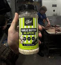 Garlic Butter Jalapeño rub jar held in a butcher shop